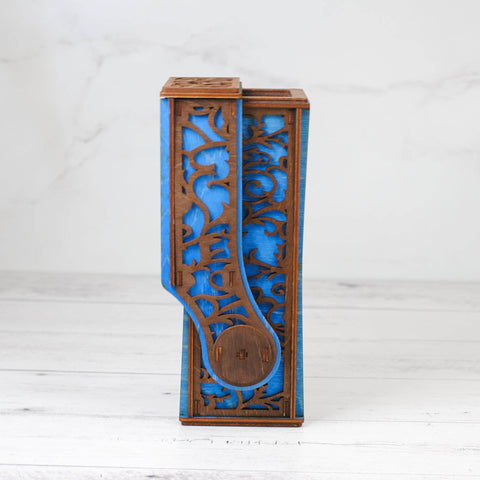 Decorative wooden vase with blue interior on a white background