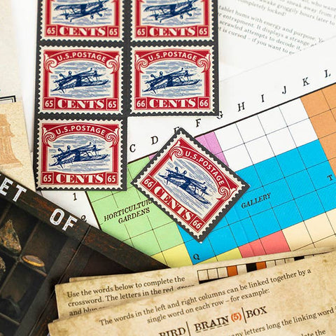 Collection of vintage stamps and postal memorabilia on a table.