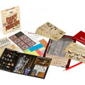 Collection of board game components including a map, cards, and solution sheet on a white background