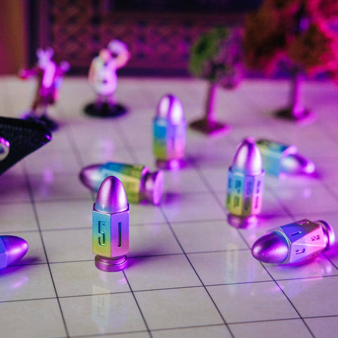 Colorful bullet-shaped objects on a reflective surface with a blurred background