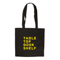 Black tote bag with yellow text 'TABLE TOP BOOK SHELF' on a white background